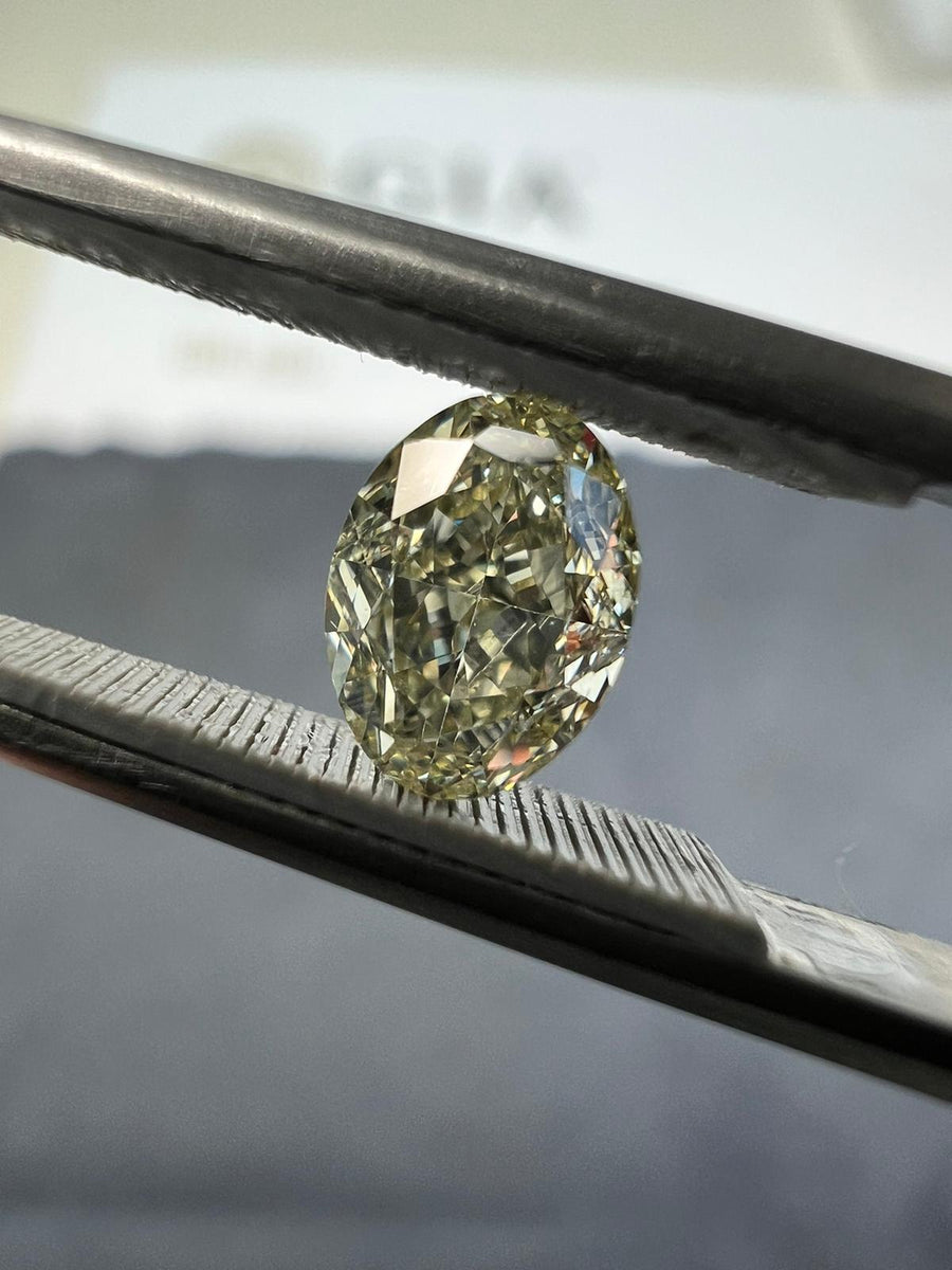 Light yellow diamond, 0.76 carat, oval shape, VS2 clarity