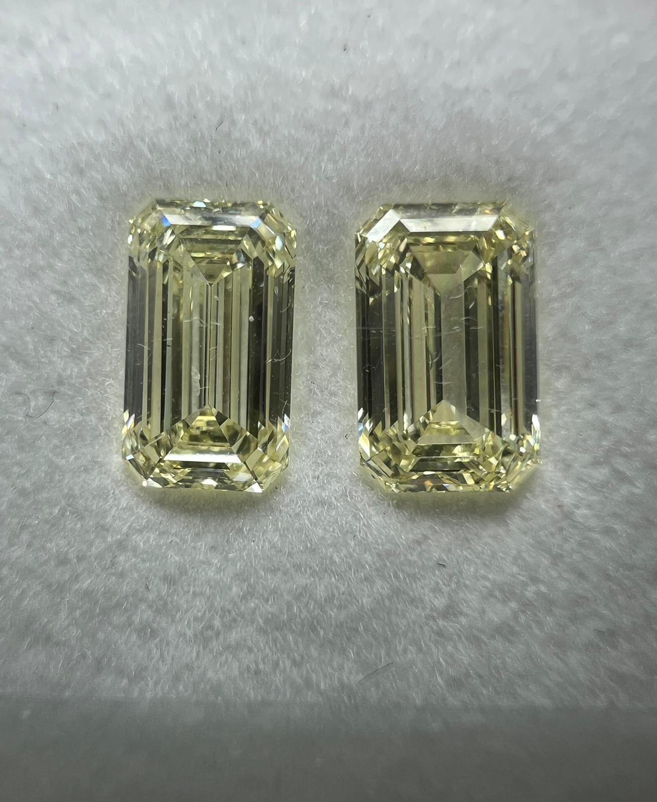 Light yellow diamonds, 1.27 & 1.26 carats, matching emerald shapes, VS1 & VVS2 clarity