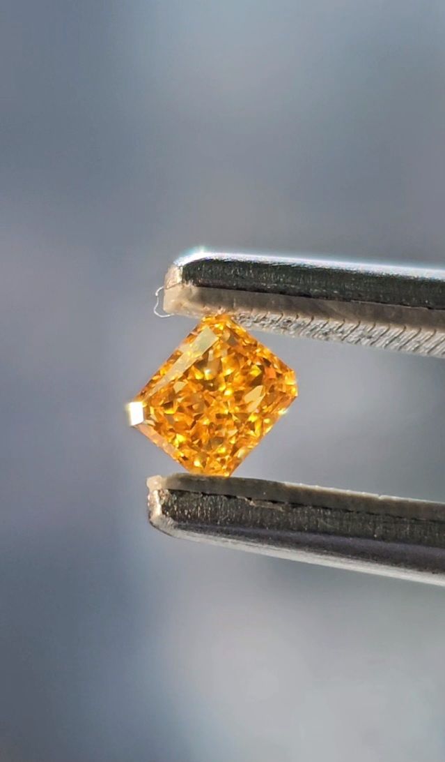 loose natural orange diamond in tweezer